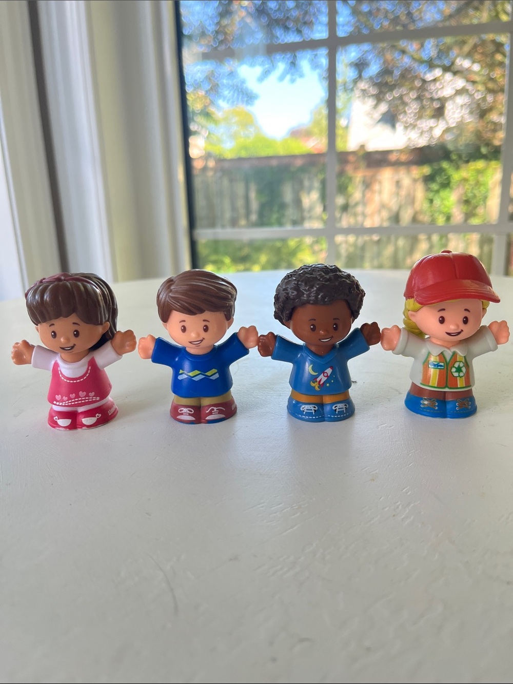 Little People Four-Piece Figure Set - Red, Pink, Blue, Brown